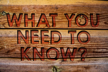 Handwriting text What You Need To Know Question. Concept meaning Education develops your knowledge and skills Wooden background vintage wood board wild message ideas intentions thoughts.
