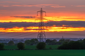 Electricity Pylon - UK standard overhead power line transmission tower at sunset