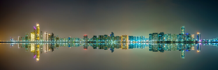 Skyline panorama of Abu Dhabi with reflections, UAE