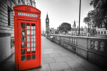 Traditional red phone box in London with the Big Ben in the background