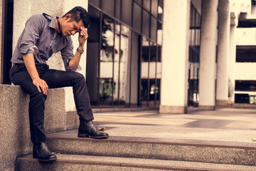unemployed businessman stress sitting on the floor or stair, failure and unemployment problem concept.