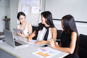 Three happy smile beautiful businesswoman working togather with laptop and tablet on the table in office.