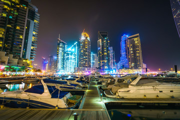 Fototapeta na wymiar Dubai marina at night viewed from boat pier, UAE