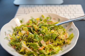 Fresh salad on the plate, close up.
