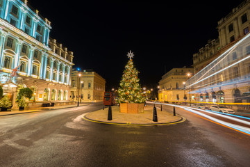 Fototapeta na wymiar Decorated christmas tree on Waterloo place street with light trails, London, England