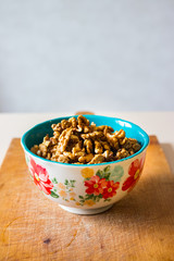 Walnuts in ceramic bowl good for salads, lunch or dinner meal and desserts. Raw vegan vegetarian healthy food.