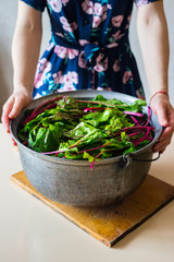Beetroot leaves and sprouts and beet in big heavy iron pot cooking and boiling for Georgian traditional food appetizer - pkhali.