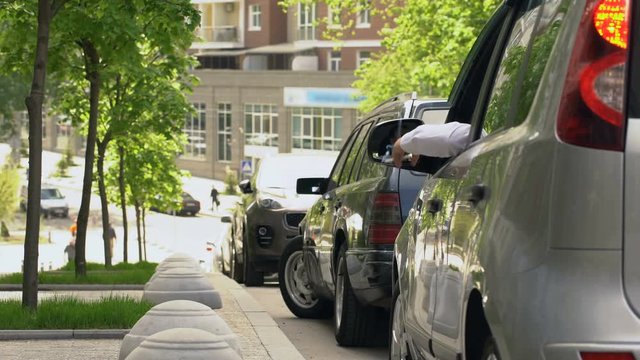 Man parking car, smoking and throwing stub on street, environmental pollution