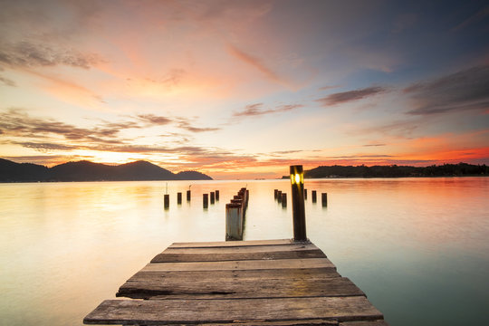 Beautiful view of sunset at Marina Island Old Jetty,Malaysia. soft focus, blur due to long exposure. Visible noise due to high ISO.