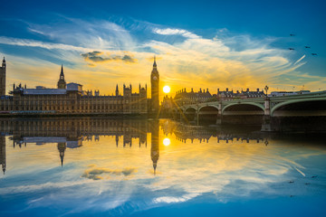 Big Ben at beautiful sunset with water reflection in London, UK