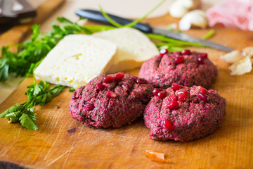 Pkhali balls - traditional Georgian food of chopped vegetables. Made of cabbage, beetroot, eggplant, spinach, beans, walnuts, adjika, vinegar, onions, garlic, and herbs. Garnished pomegranate kernels.