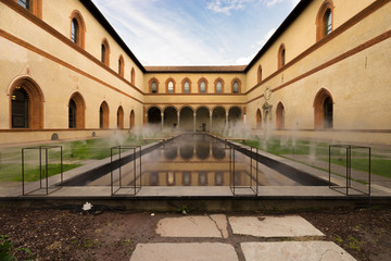 Fototapeta na wymiar Foggy square of medieval castle Castello in Milan, Italy
