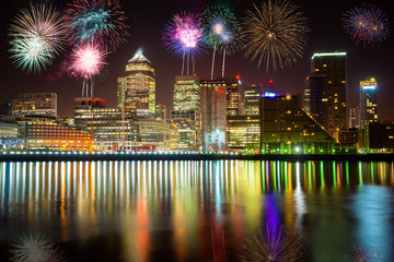 Canary Wharf business district at night with firework, celebration of the New Year in London, UK