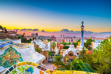 View of mosaic tile and Barcelona cityscape in park Guell at sunset | Spain - obrazy, fototapety, plakaty