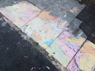 colorful chalk on grey stones