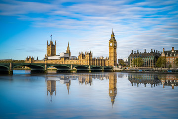 Fototapeta na wymiar Big Ben and Westminster with blue sky and water reflection