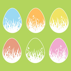 Set of colored isolated Easter eggs on a green background. With a white stroke. Silhouette of grass and leaves inside. Simple flat vector illustration. Suitable for decoration of postcards