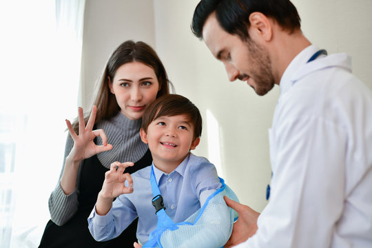 Health Concepts. The doctor is splinting to the patient. The doctor is examining a bone splint. Little children are happy in the healing of the doctor. Close-up image of a doctor