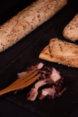 Octopus slice with cereal bread plated