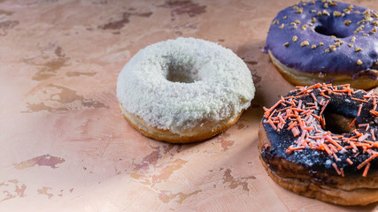 Donuts with colorful icing on a concrete background. Close-up