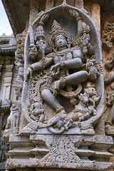 Fototapeta na wymiar Ornate wall panel reliefs depicting Shiva dancing on the head of Gajasura, Kedareshwara temple, Halebidu, Karnataka