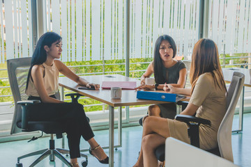 Fototapeta premium Asian office worker sitting in a relaxed meeting at work.