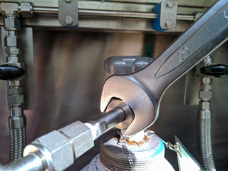 Technical use Adjustable wrench tightening up helium tank.