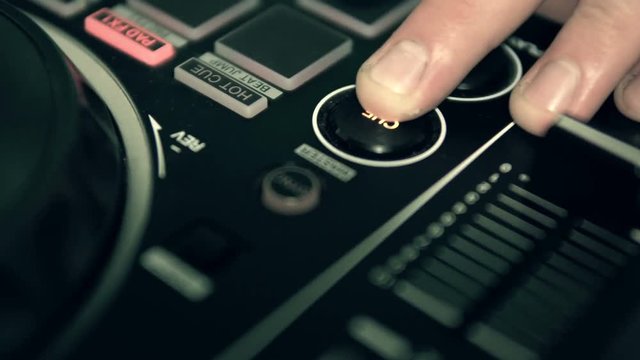 DJ tweak track controls on DJ control panel.