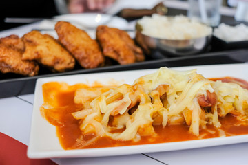 Korean food, Tteok-bokki with cheese in the restaurant. (Tteok-bokki or stir-fried rice cakes)