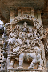 Obraz premium Ornate wall panel reliefs depicting Shiva-Parvati sitting on Nandi, North wall, Kedareshwara temple, Halebidu, Karnataka