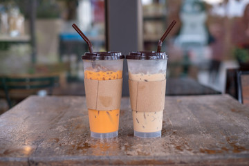 Thai Ice Tea and thai ice tea with milk and non milk on wooden table