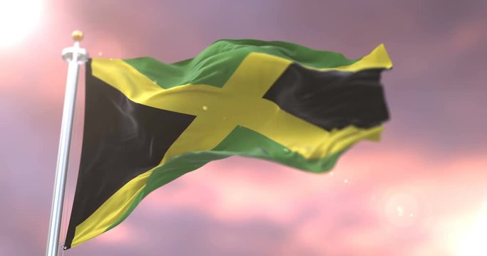 Flag of Jamaica waving at wind at sunset in slow, loop