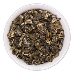 Pile of dry green tea Bilochun snail in white bowl isolated on white background. Top view from above
