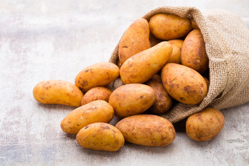 A bio russet potato wooden vintage background.
