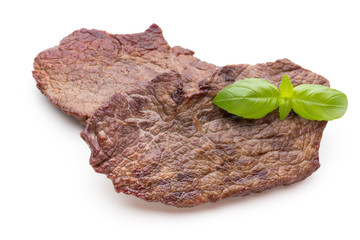 Grilled beef steaks with spices isolated on white background.