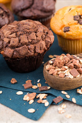 Homemade muffins with chocolate, vintage background.