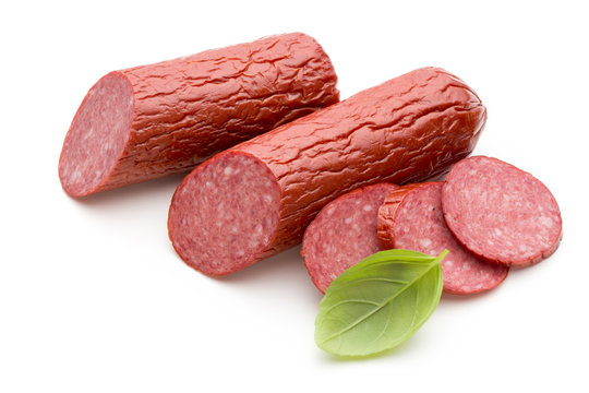 Salami smoked sausage, basil leaves on white background cutout.