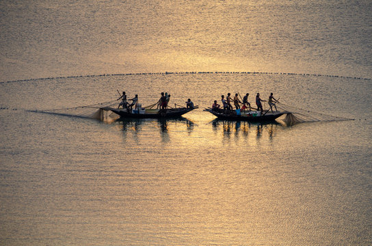 Fishing on the Damodar River during sunset