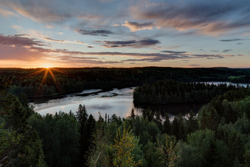 Naklejka na ściany i meble Scenic and beautiful view of a lake, forest and sky from the Aulanko lookout tower in Hämeenlinna, Finland, in the summer at sunrise.