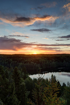Scenic and beautiful view of a lake, forest and sky from the Aulanko lookout tower in Hämeenlinna, Finland, in the summer at sunrise. Copy space. © tuomaslehtinen