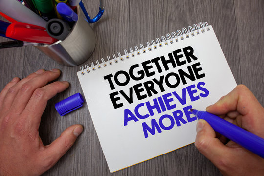 Text sign showing Together Everyone Achieves More. Conceptual photo Teamwork Cooperation Attain Acquire Success Man hold holding blue marker notebook page markers table messages ideas.