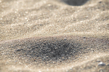 Fototapeta na wymiar Soft Wave Of Blue Ocean On Sandy Beach. Background. Selective focus.