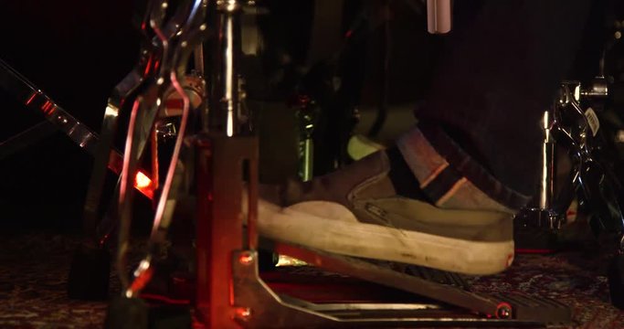 Man hits kick drum pedal with feet.
