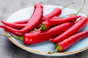 Chili cayenne pepper on grey background.