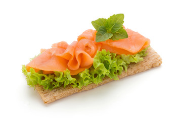 Bread with fresh salmon fillet isolated on white background, top view.