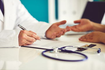 The male doctor in the office has consulted with his patient