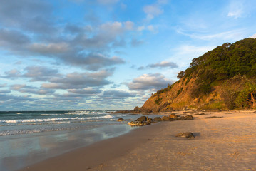 The sunset on the beach with next to the rocky mountain, Byron Bay, Australia