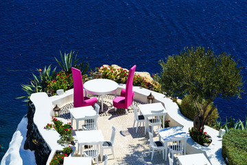 Tables at the cliff near Aegean sea,Santorini, Greece
