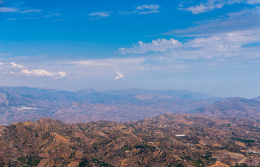 beautiful view of the mountains in the region of Andalusia, houses and farmland on the slopes of mountains