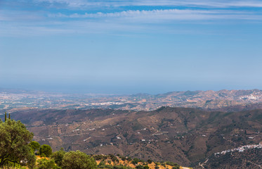 beautiful view of the mountains in the region of Andalusia, houses and farmland on the slopes of mountains